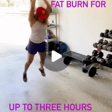 Andrea mid-jump during a HIIT set in the garage gym.