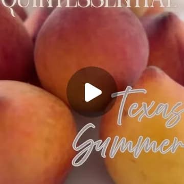 A pile of ripe Texas summer peaches on a white plate.