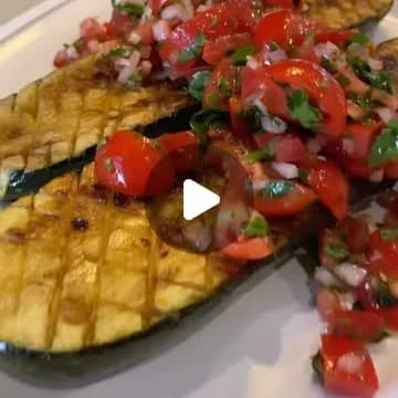 Grilled zucchini planks topped with fresh pico de gallo.